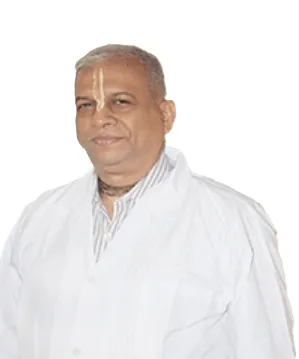Dr Mukund Shanbhag in a white clinical coat